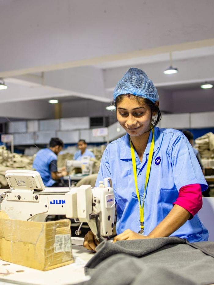 A worker sewing at a garment factory