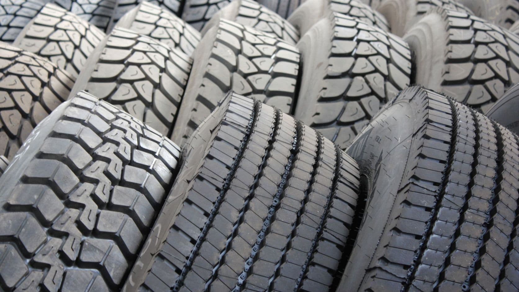 Rows of stacked tyres showing their tread patterns